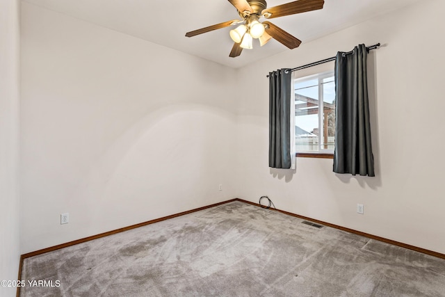 spare room with light carpet, baseboards, visible vents, and ceiling fan