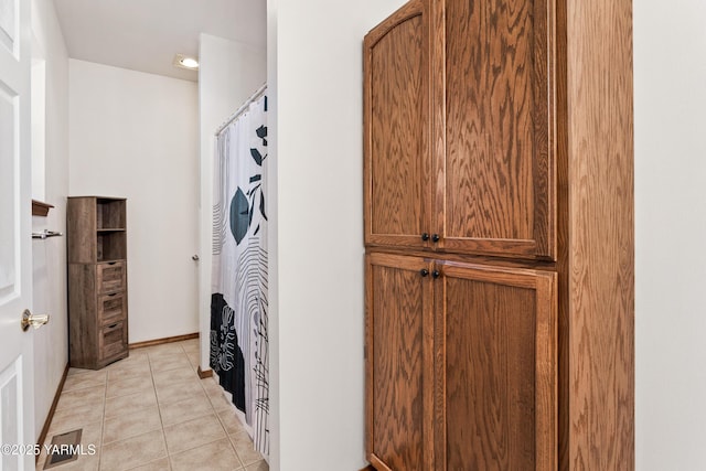 bathroom featuring baseboards and tile patterned floors