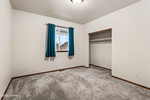 unfurnished bedroom with light carpet, baseboards, visible vents, and a closet