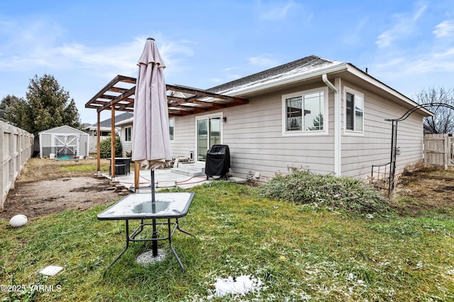 back of house featuring a yard, a storage shed, a pergola, a fenced backyard, and an outdoor structure