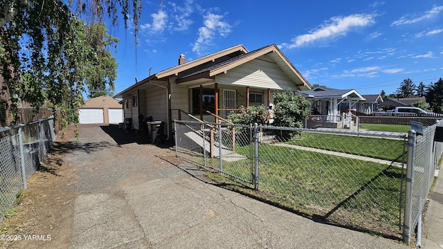 807 S 11th Ave, Yakima, WA 98908 - view of front facade with a porch, a fenced front yard, a gate, and a garage
