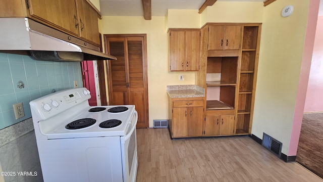 807 S 11th Ave, Yakima, WA 98908 - kitchen with electric range, under cabinet range hood, light wood-type flooring, brown cabinets, and beamed ceiling
