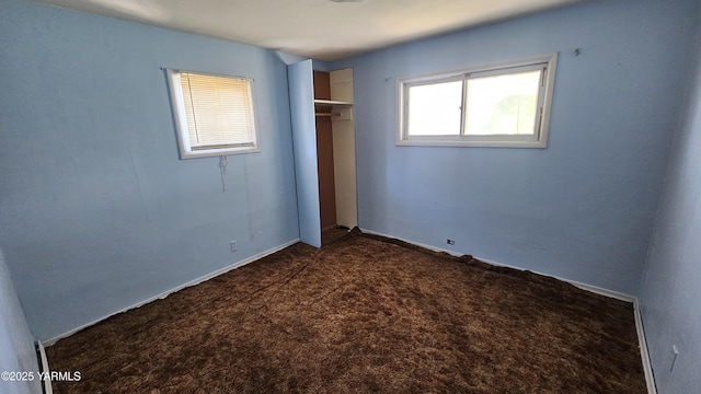 807 S 11th Ave, Yakima, WA 98908 - unfurnished bedroom featuring dark colored carpet and a closet
