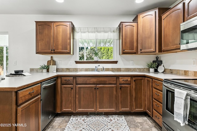5807 W Whatcom Ave, Yakima, WA 98903 - kitchen with appliances with stainless steel finishes, a peninsula, light countertops, and recessed lighting