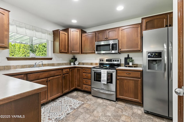 5807 W Whatcom Ave, Yakima, WA 98903 - kitchen featuring appliances with stainless steel finishes, light countertops, recessed lighting, and stone finish flooring