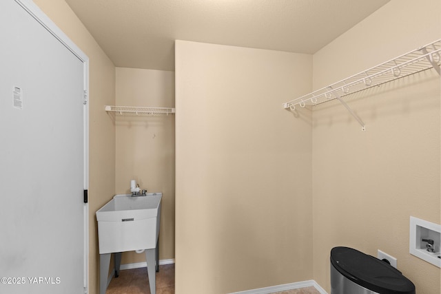 walk in closet featuring a sink