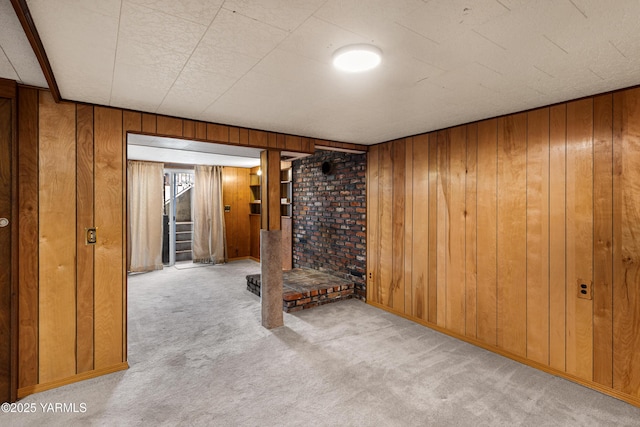 unfurnished room with carpet floors and wooden walls