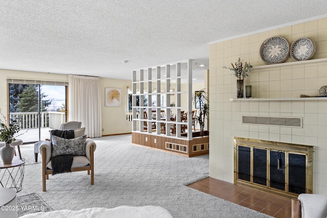 carpeted living area featuring a fireplace, visible vents, and a textured ceiling