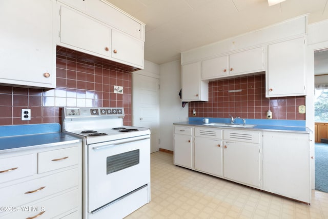 kitchen with light countertops, white electric range, light floors, white cabinetry, and a sink