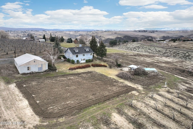 drone / aerial view featuring a rural view and a mountain view