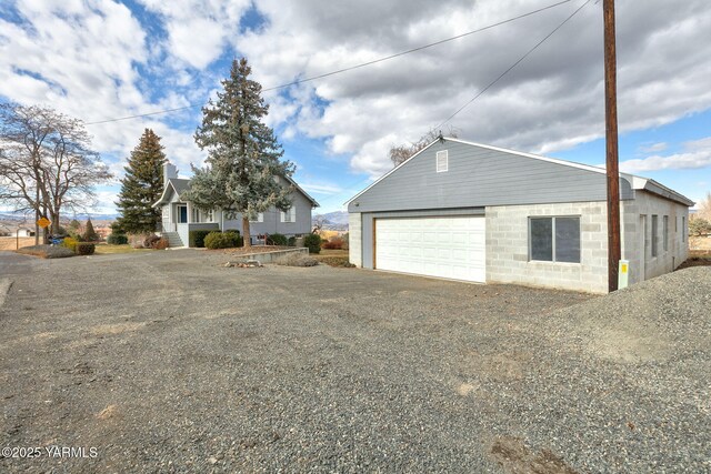 garage with gravel driveway