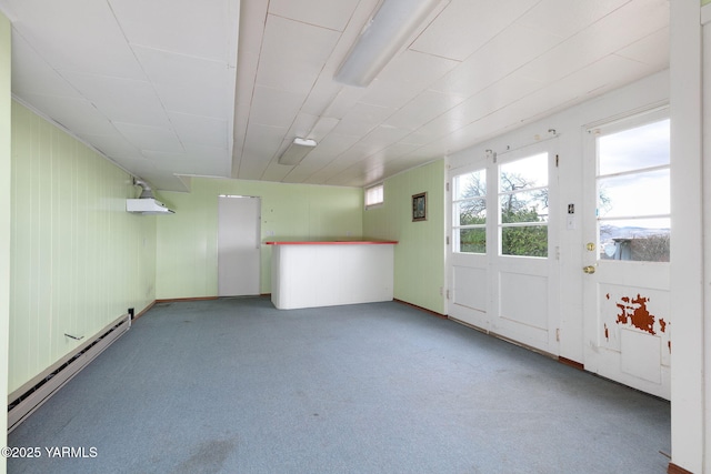 spare room featuring baseboard heating and carpet flooring