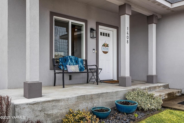 view of exterior entry featuring stucco siding