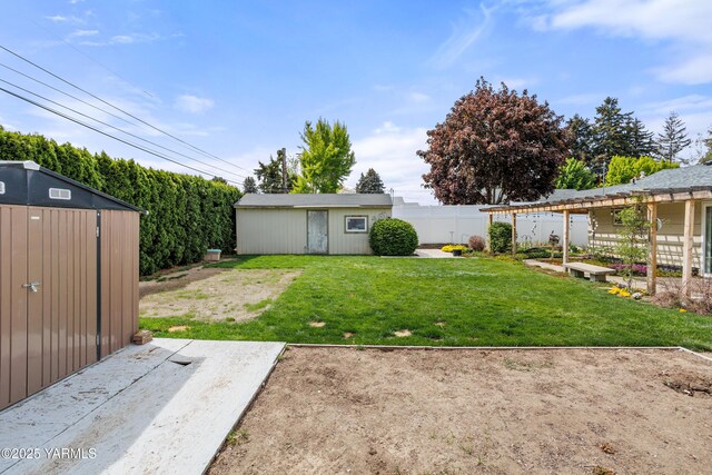 view of yard with fence and an outdoor structure