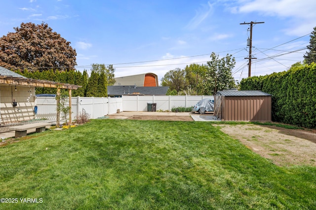 view of yard featuring a storage shed, an outbuilding, and a fenced backyard