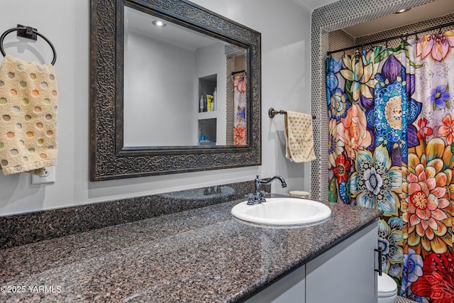 full bath featuring toilet, a shower with shower curtain, and vanity