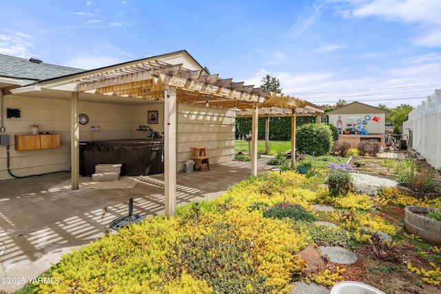 exterior space with a hot tub, fence, and a pergola