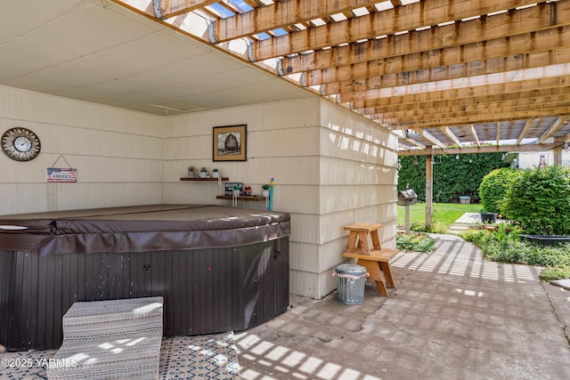 view of patio / terrace with a hot tub and a pergola