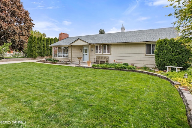 single story home with a shingled roof, a chimney, and a front lawn