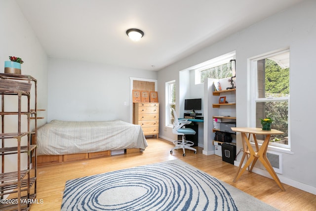 bedroom featuring wood finished floors and baseboards