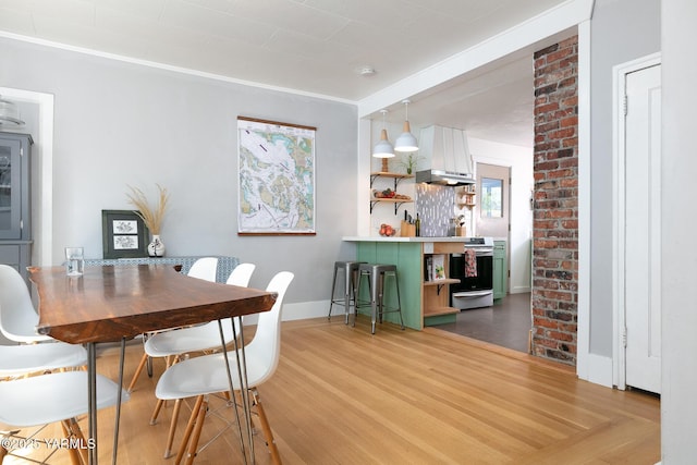dining space featuring baseboards and wood finished floors