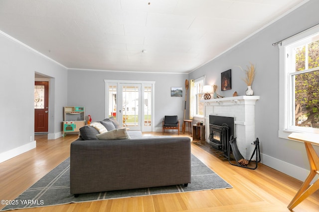 living room featuring french doors, crown molding, wood finished floors, and baseboards