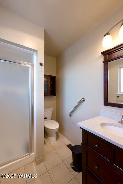 215 N 56th Ave Unit 42, Yakima, WA 98908 - bathroom with vanity, a stall shower, and tile patterned floors