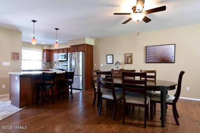 215 N 56th Ave Unit 42, Yakima, WA 98908 - dining space featuring dark wood-type flooring and a ceiling fan