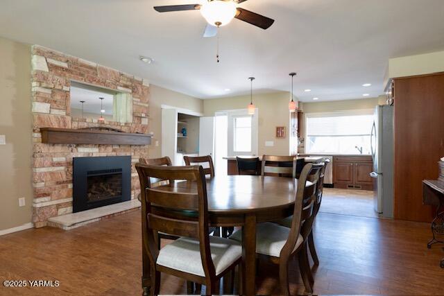 215 N 56th Ave Unit 42, Yakima, WA 98908 - dining room featuring wood finished floors, ceiling fan, a fireplace, and recessed lighting