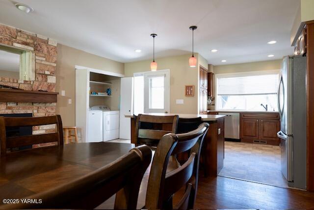215 N 56th Ave Unit 42, Yakima, WA 98908 - dining room with plenty of natural light, washing machine and clothes dryer, a fireplace, light wood-style floors, and recessed lighting