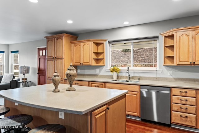 kitchen featuring open shelves, light countertops, a kitchen island, a sink, and dishwasher