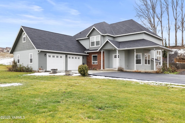 view of front facade with brick siding, roof with shingles, an attached garage, and a front lawn