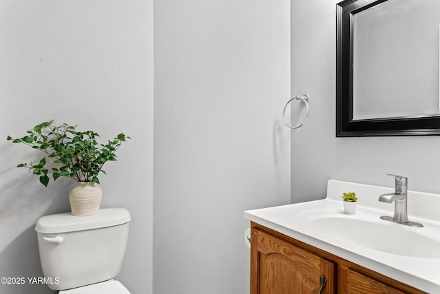 half bathroom with toilet and vanity