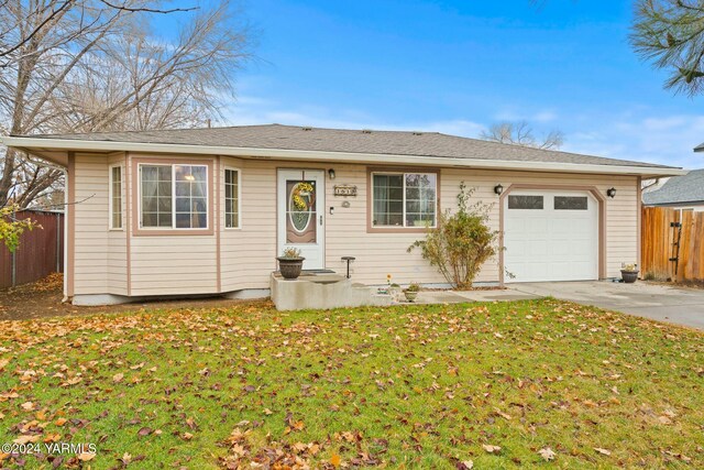 ranch-style house featuring a garage, a front yard, fence, and driveway