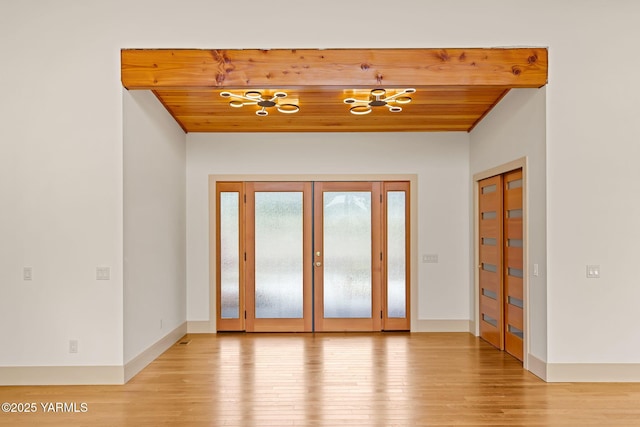 8 N 96th Ave, Yakima, WA 98908 - empty room featuring wood ceiling, light wood-style floors, a chandelier, and french doors