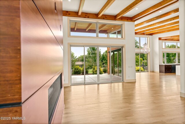 8 N 96th Ave, Yakima, WA 98908 - unfurnished living room with beamed ceiling, hardwood / wood-style flooring, a chandelier, and a towering ceiling