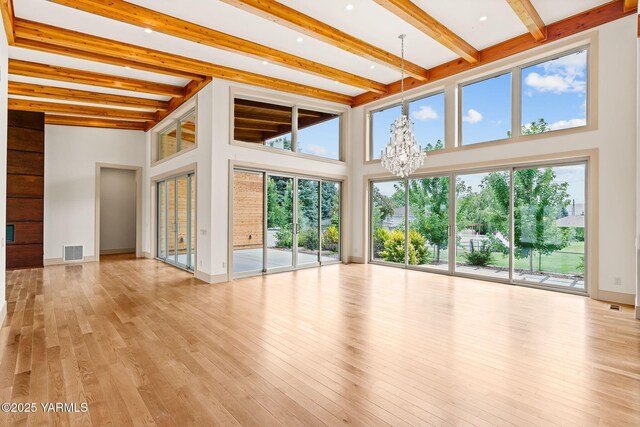 8 N 96th Ave, Yakima, WA 98908 - unfurnished room featuring a chandelier, beamed ceiling, light wood-style flooring, and a towering ceiling
