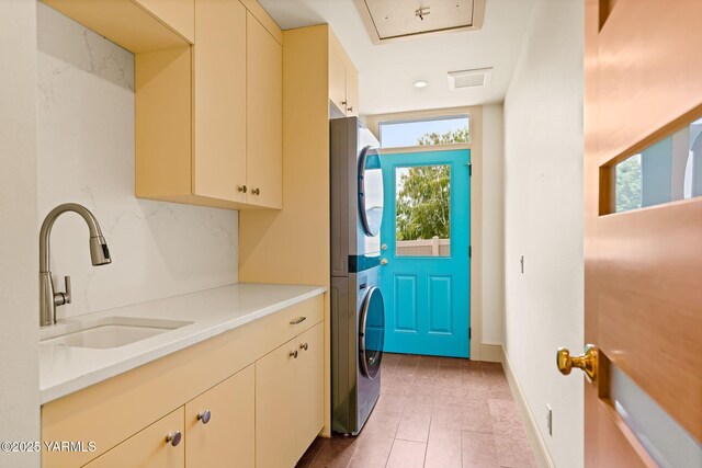 8 N 96th Ave, Yakima, WA 98908 - washroom with cabinet space, stacked washer / dryer, and tile patterned flooring