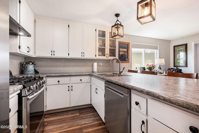 kitchen featuring a sink, decorative backsplash, white cabinetry, and stainless steel appliances