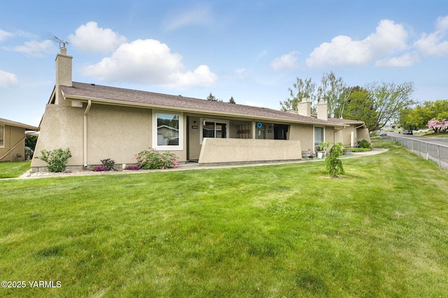 ranch-style house with fence, a chimney, stucco siding, and a front yard