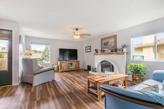 living room featuring a textured ceiling, a healthy amount of sunlight, and wood finished floors