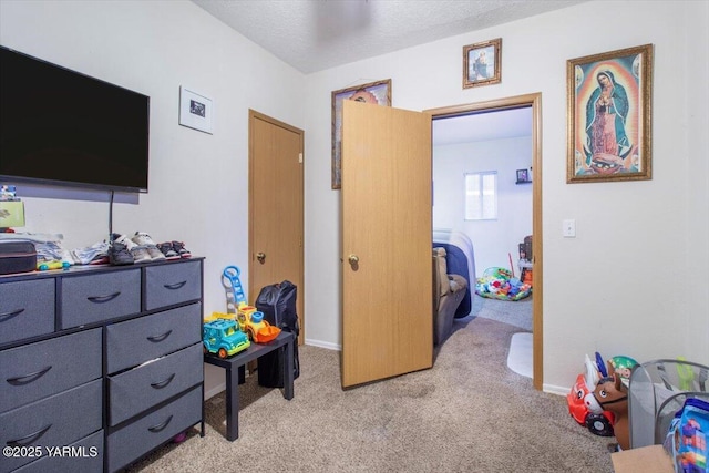 game room with light carpet, baseboards, and a textured ceiling