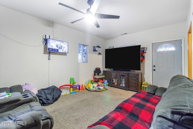 living area with ceiling fan, speckled floor, and a healthy amount of sunlight