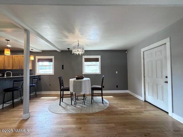 1115 S 20th Ave `, Unit Yakima, WA 98902 - dining area with baseboards, a chandelier, light wood-style flooring, and beam ceiling