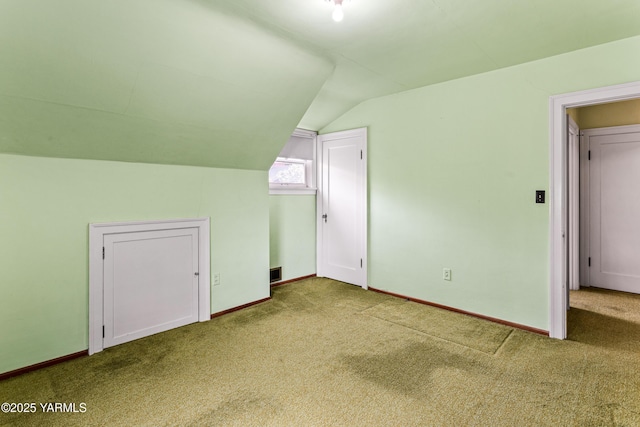 bonus room featuring carpet, lofted ceiling, and baseboards