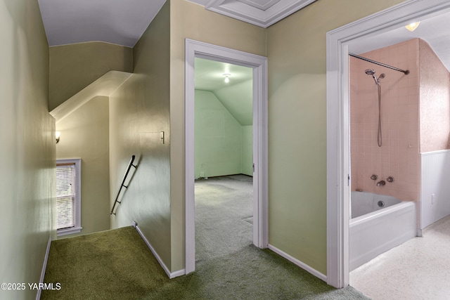 corridor featuring vaulted ceiling, carpet, and baseboards