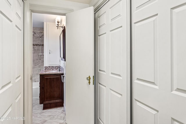 corridor featuring light marble finish flooring