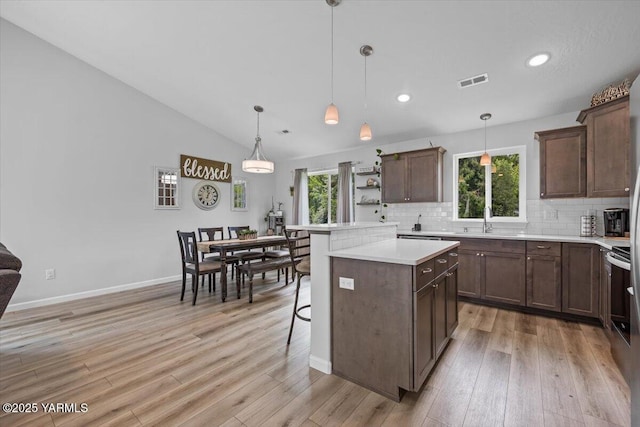 19700 N Beers Rd, Prosser, WA 99350 - kitchen featuring light wood finished floors, tasteful backsplash, light countertops, open shelves, and recessed lighting