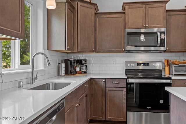 19700 N Beers Rd, Prosser, WA 99350 - kitchen featuring stainless steel appliances, decorative backsplash, and light countertops
