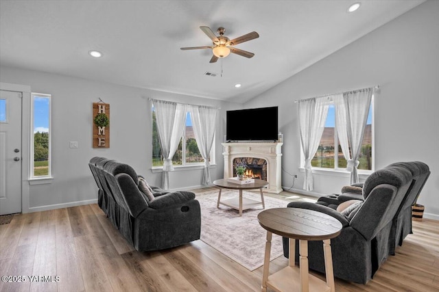19700 N Beers Rd, Prosser, WA 99350 - living area with a ceiling fan, light wood-type flooring, lofted ceiling, a warm lit fireplace, and recessed lighting